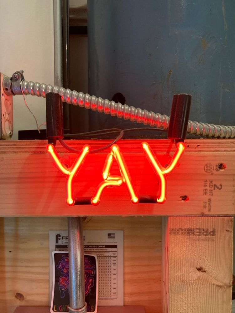 The word, "YAY," in neon.