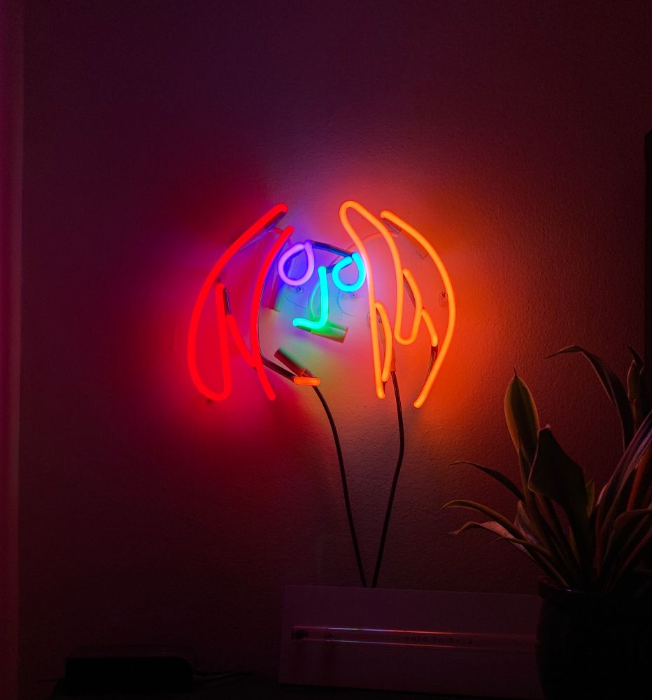 Neon rendering of John Lennon's self-portrait.