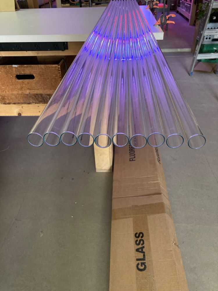 A photo showing 10, 25mm, 8 foot long clear glass tubes lined up next to each other.