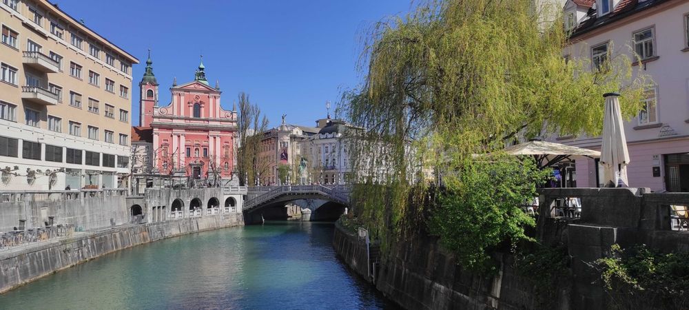 A photograph overlooking the Ljubljanica river in Ljubljana.
