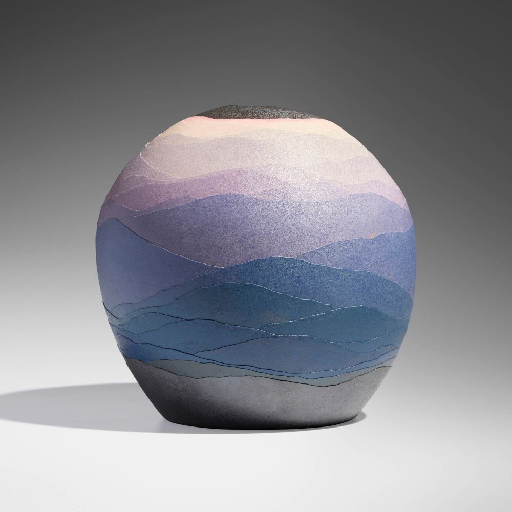 Rounded ceramic vessel with layers of colored clay forming a gradient moving from deep blue on the bottom up to purple and pink, resembling a mountain landscape.