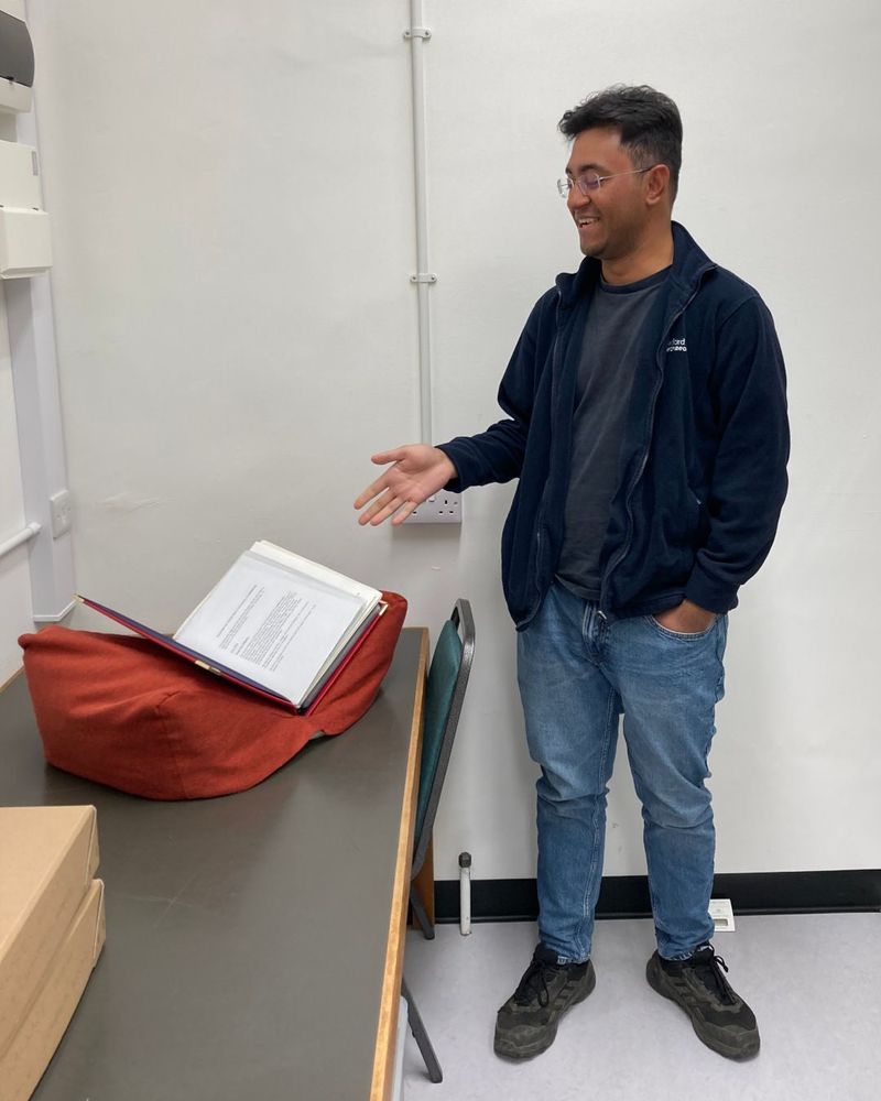Volunteer with a scrapbook on a book rest