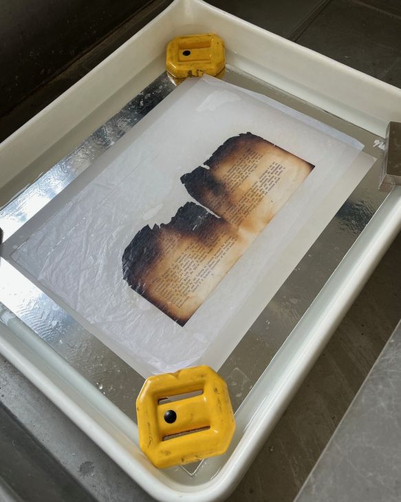 ‘Float’ washing a page to remove staining and other adverse chemicals