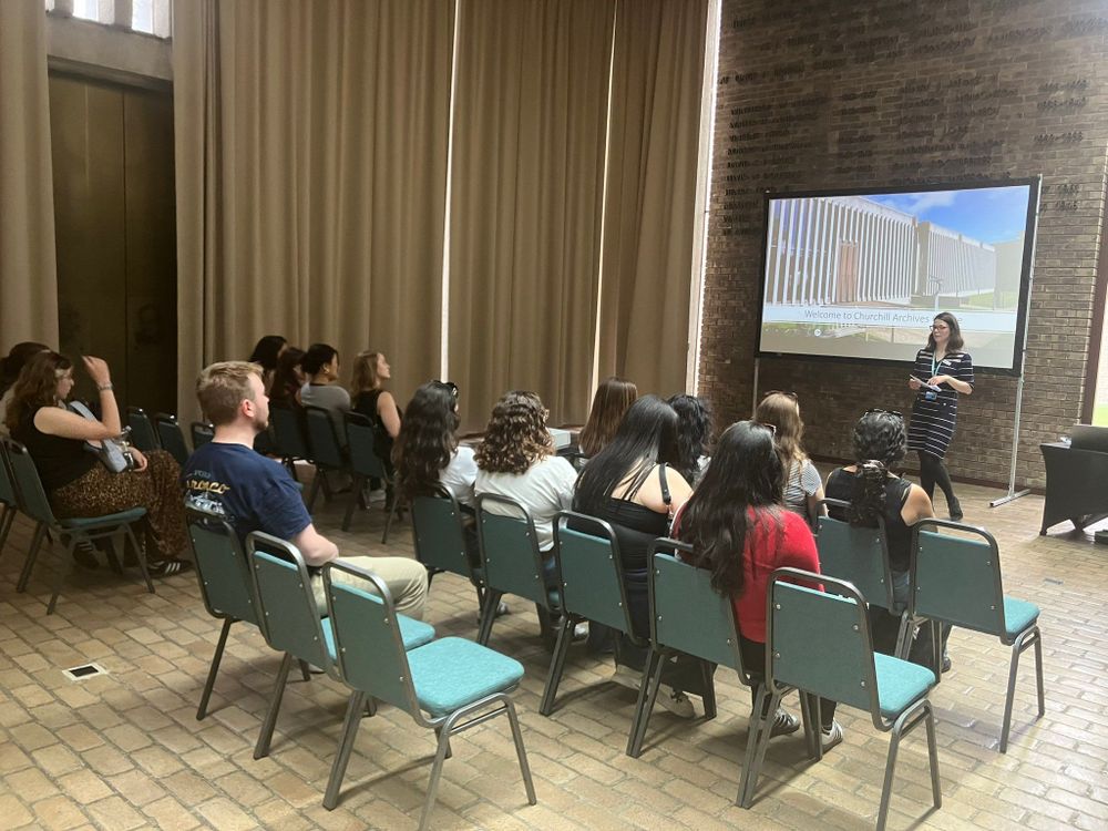 Photo of students listening to a lecture about the archives