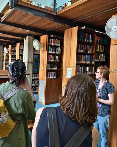  Annie explaining the different spaces available to students in the Churchill College library