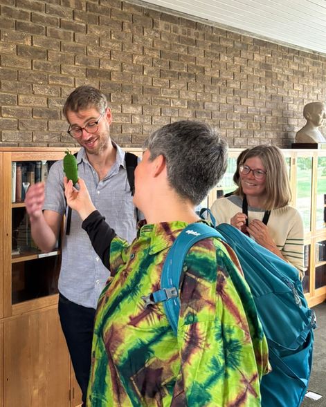 Visitors showing each other the library's fruit-themed study buddies
