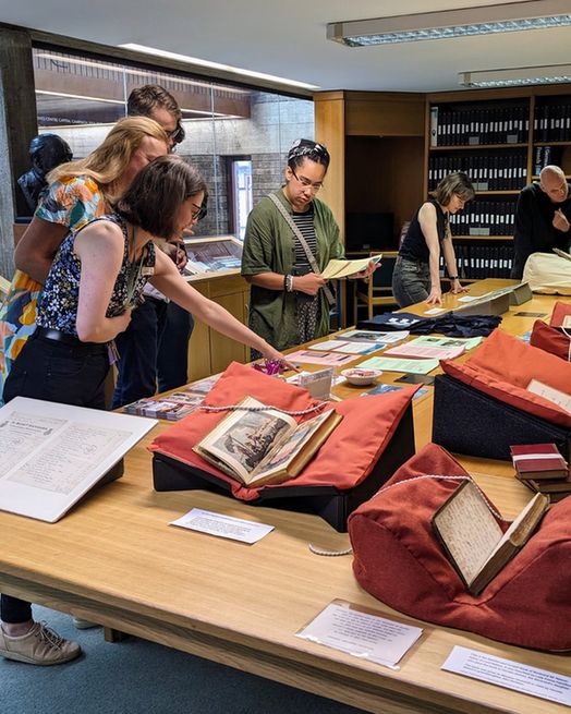 Visitors looking at a reading room exhibition, bringing together rare books and archive material on Balliol College