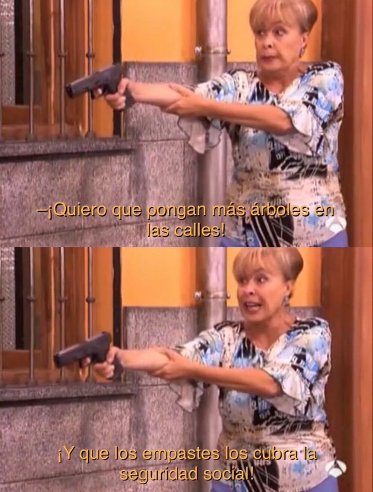Vicenta de “Aquí no hay quien viva” apuntando con un arma de fuego mientras dice “¡Quiero que pongan más árboles en las calles! ¡Y que los empastes los cubra la seguridad social!