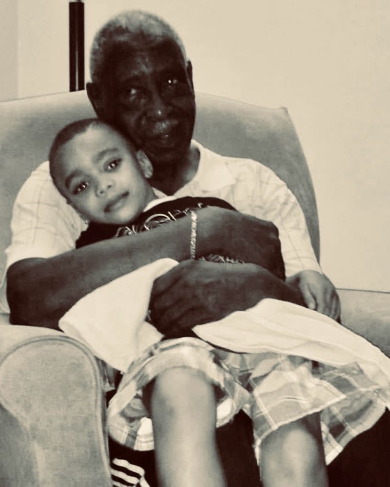 Grandpa with his great grandson in a black and white image 