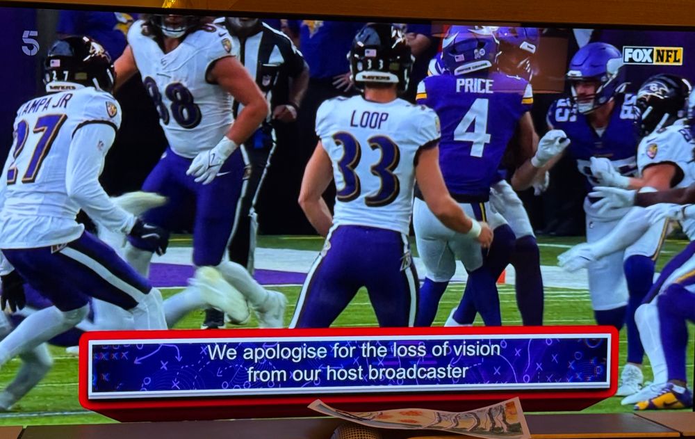 Image of a TV screen showing FOX NFL coverage with a subtitle saying "We apologise for the loss of vision from our host broadcaster". 