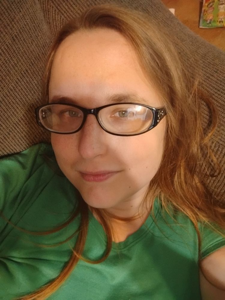 Robin a white woman  with brown hair and glasses