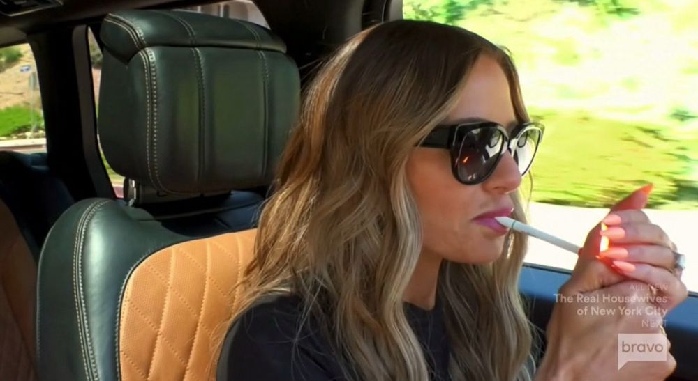 RHOBH Dorit Kemsley lighting a cigarette in the car