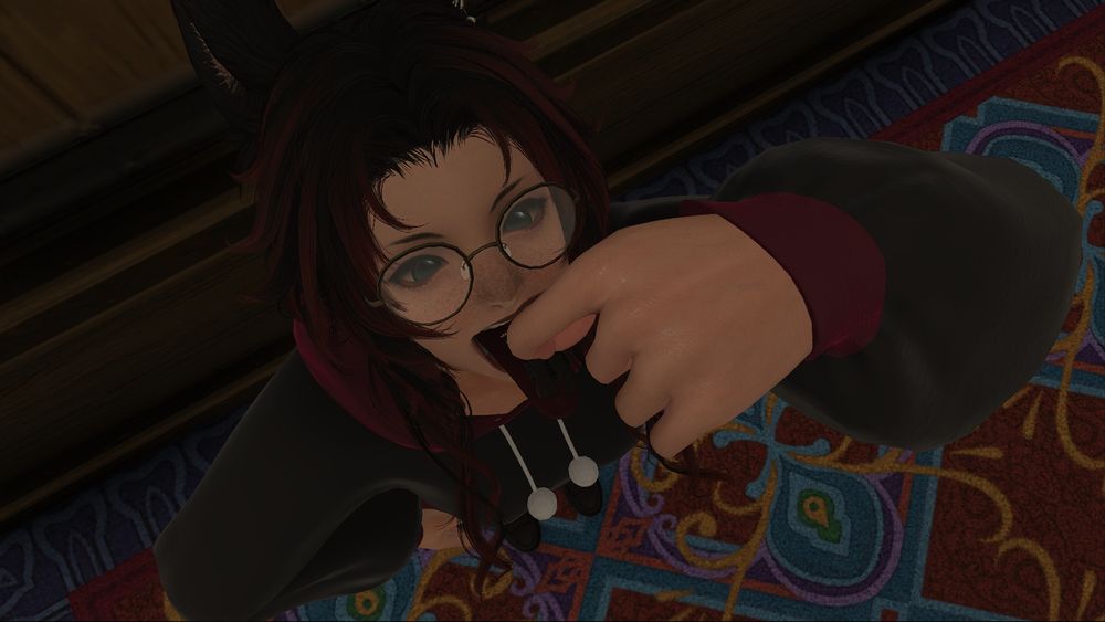 A red and black haired Viera holding a tiny blue haired Lalafell up to her open mouth with her tongue out.