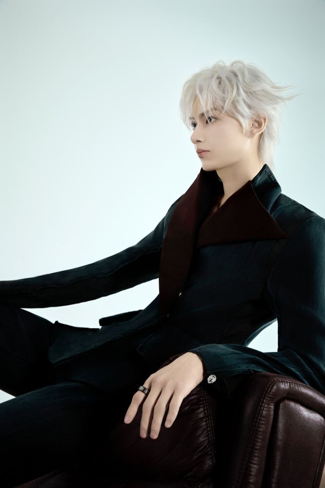 Seventeen's Jun looking gorgeous and jack skellington-esque in a black suit with that good good white gojo hair