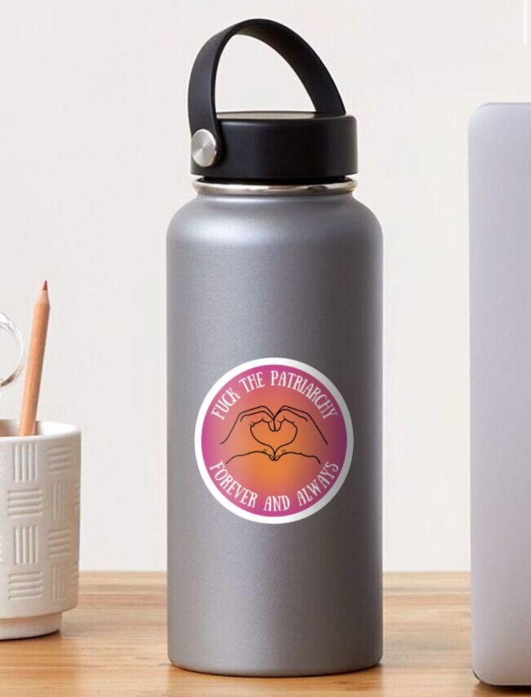 Pink and gold background with the text that reads “fuck the patriarchy forever and always” with an outline of hands in the shape of a heart sticker displayed on a gray water bottle