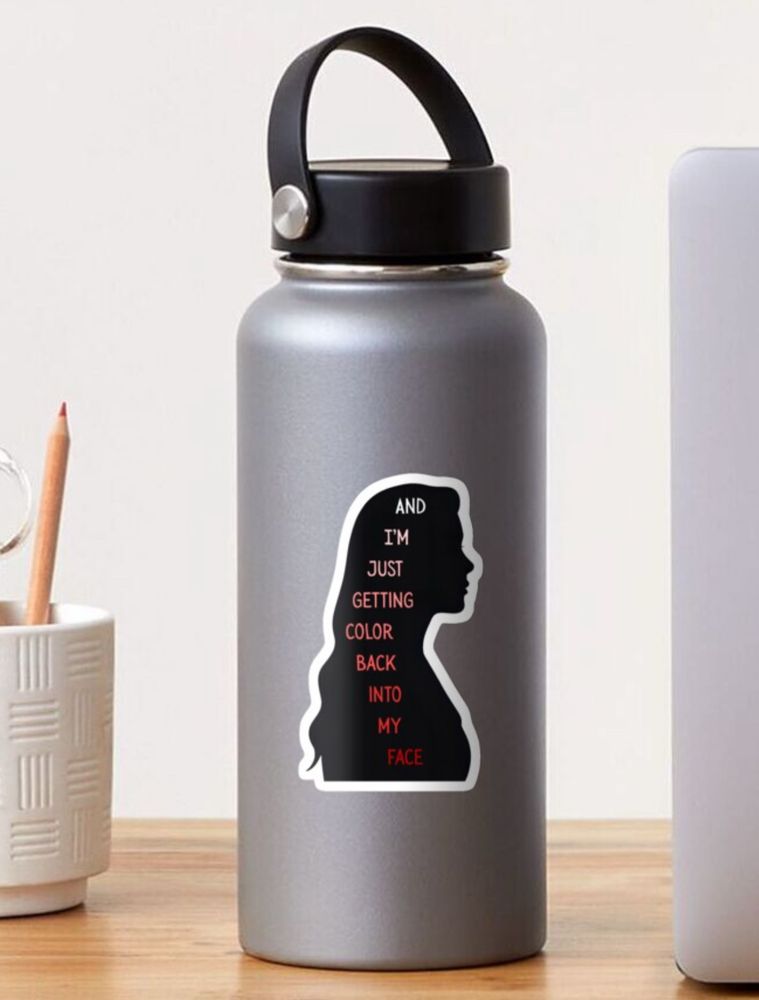 Sticker of a black silhouette of a woman’s side profile with text that reads “I’m just getting color back into my face” with the colors going from white to to pink to red displayed on a gray water bottle