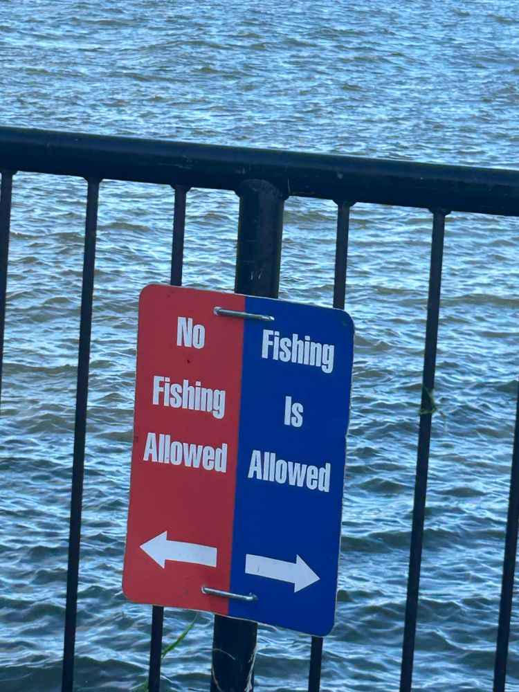 2 signs. One says No Fishing Allowed. The other says Fishing Is Allowed.