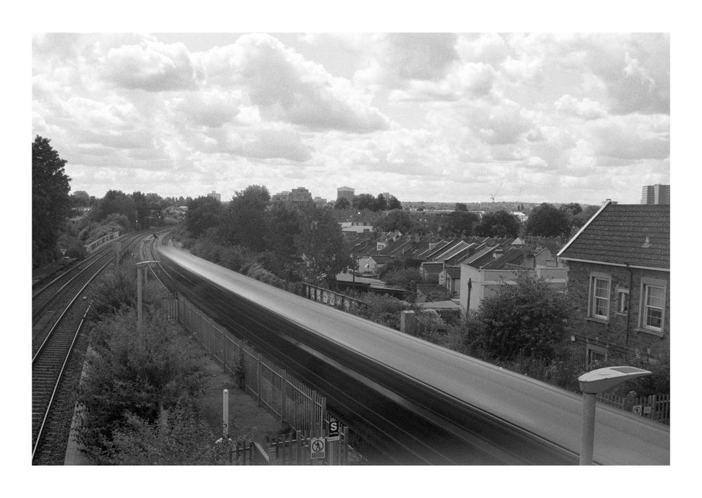 Long exposure photograph of train blur heading into distance 