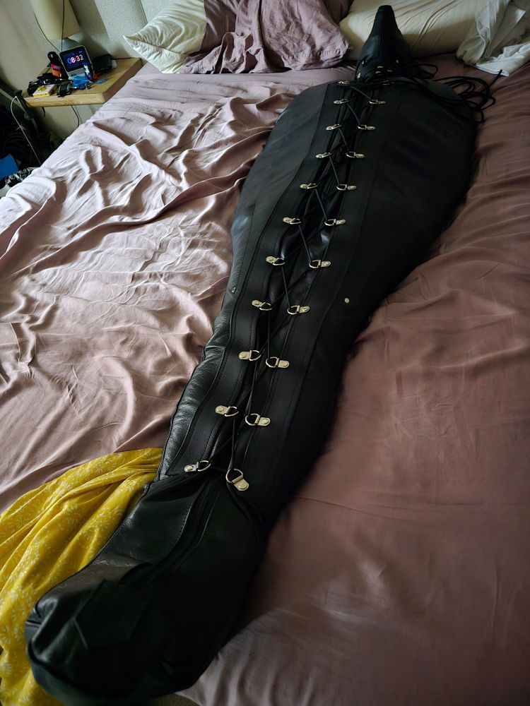 Gimp in a sleep sack still in bed in the early morning light