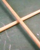 Two cues crossed on a pool table.