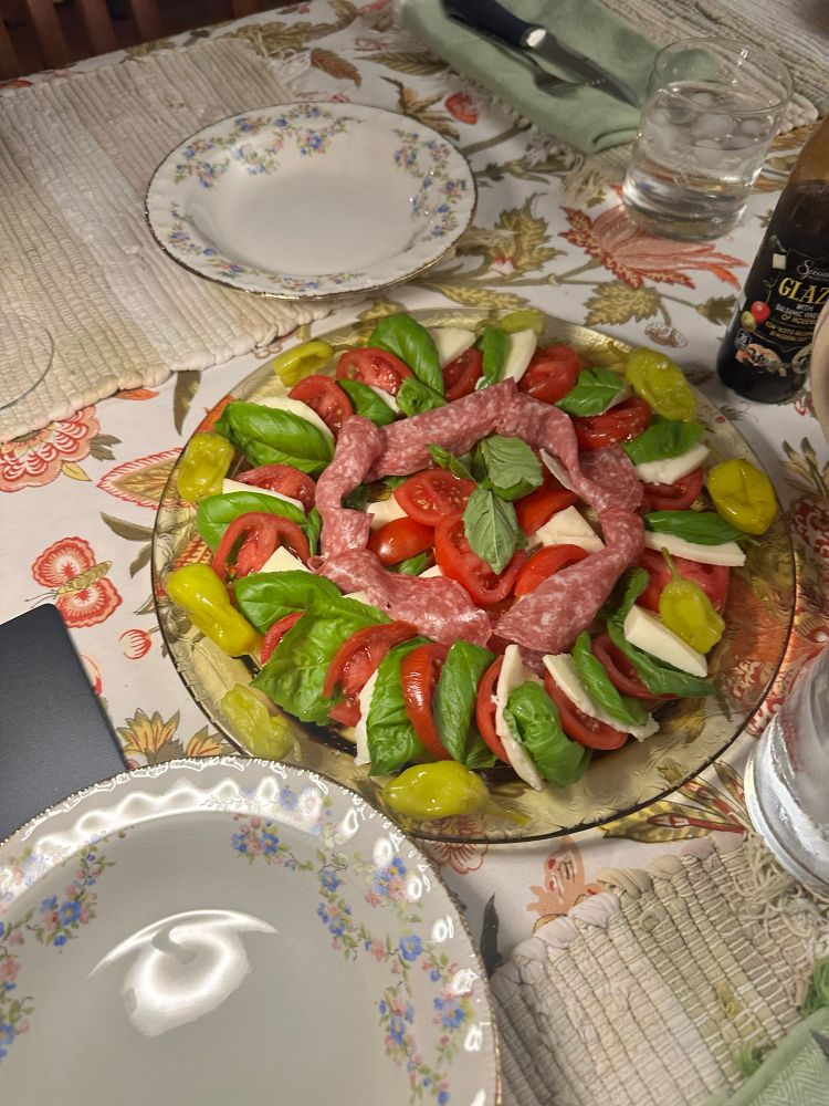 salad plate of cheese, greens, deli meat, and pepperoncini 