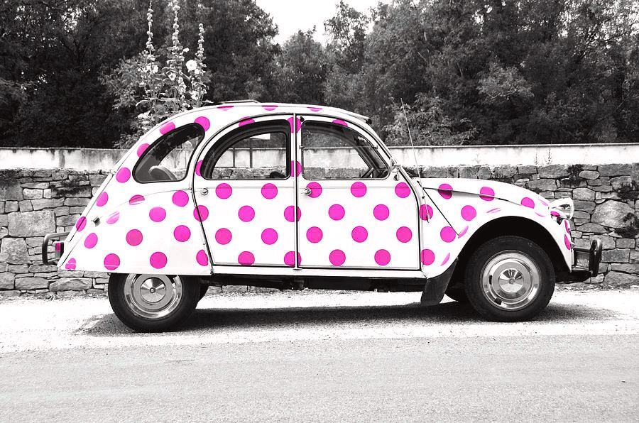 "Pink Polka Dot Citroën 2CV" by Susan Maxwell Schmidt 

An altered selective color photograph of a white Citroën 2CV with bright pink polka dots. The original 2CVs were nicknamed the "umbrella on wheels" because they had a full-width canvas roof that rolled all the way back almost to the bumper on pre-1955 models (I believe this model was made around 1965 but I wasn't able to definitively date it, if you know please share your knowledge!). And here's a piece of trivia for you: Michelin introduced their very first radial tires on the first model of this French car in 1948. Most importantly, I want one! More info at susanmaxwellschmidt.com 