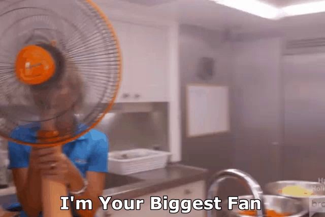 a person holding a fan over their head with the words i 'm your biggest fan below them