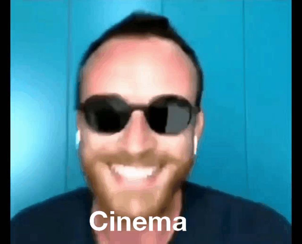 a man wearing sunglasses and smiling with the word cinema written on his face