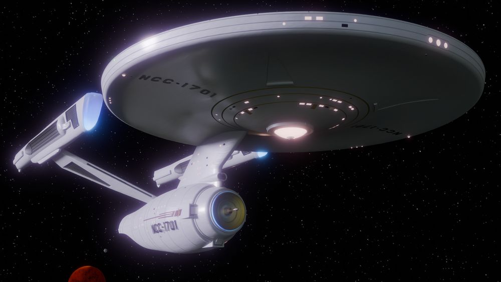 The Star Trek Phase 2 version of the Enteprise (Phase 2 was a pertially developed but never-aired Star Trek TV show in the late 1970s - shortly before shooting began, it was retooled into the first film, The Motion Picture, and this version of the Enterprise never saw the light of space) sits in space near a red planet, looking stately and regal in porcelain white.