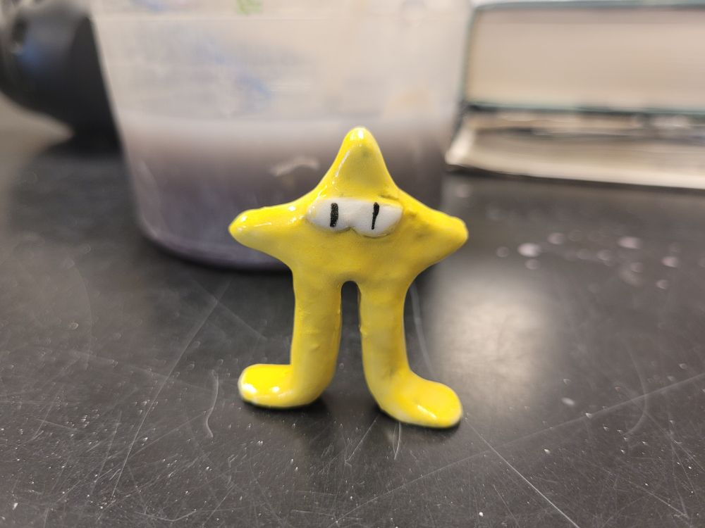 Ceramic Starwalker with a bowl of paint water behind him.