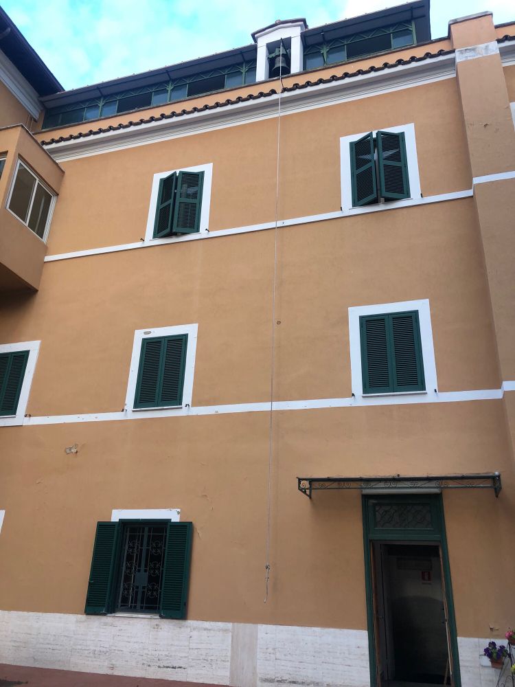 On an orange wall in a nun cloistered space has a rope tied to a bell. The urge to pull the rope vigorously is almost unbearable 