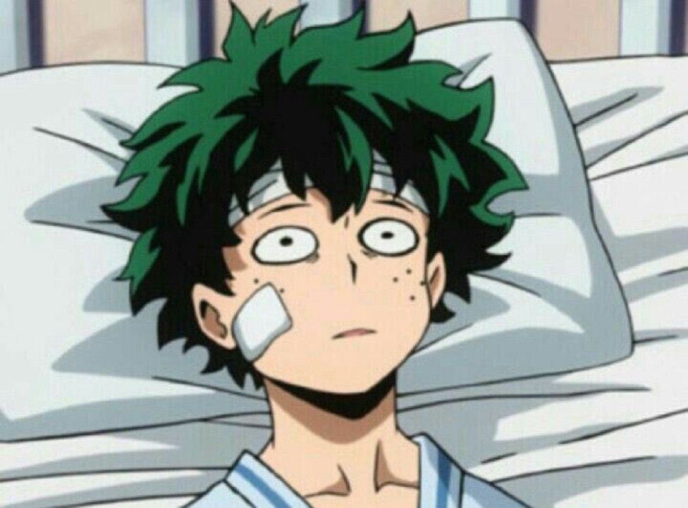 Deku from My Hero Academia laying in a hospital bed with a vacant expression 
