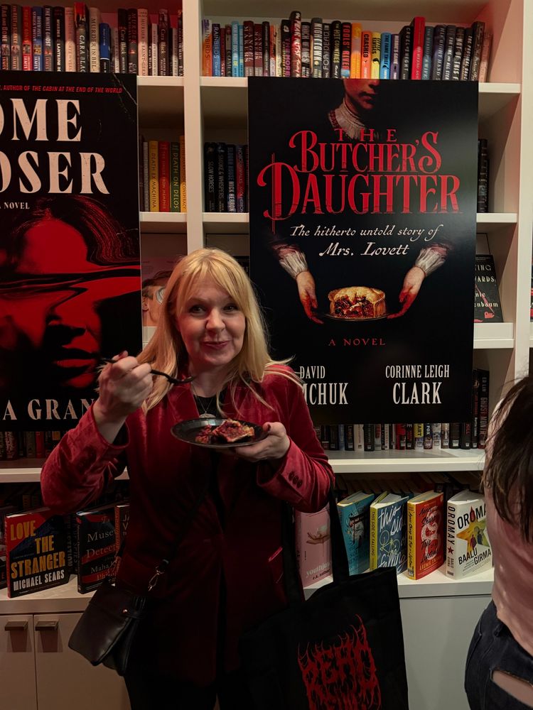 Blonde female author taking a bite of pie.