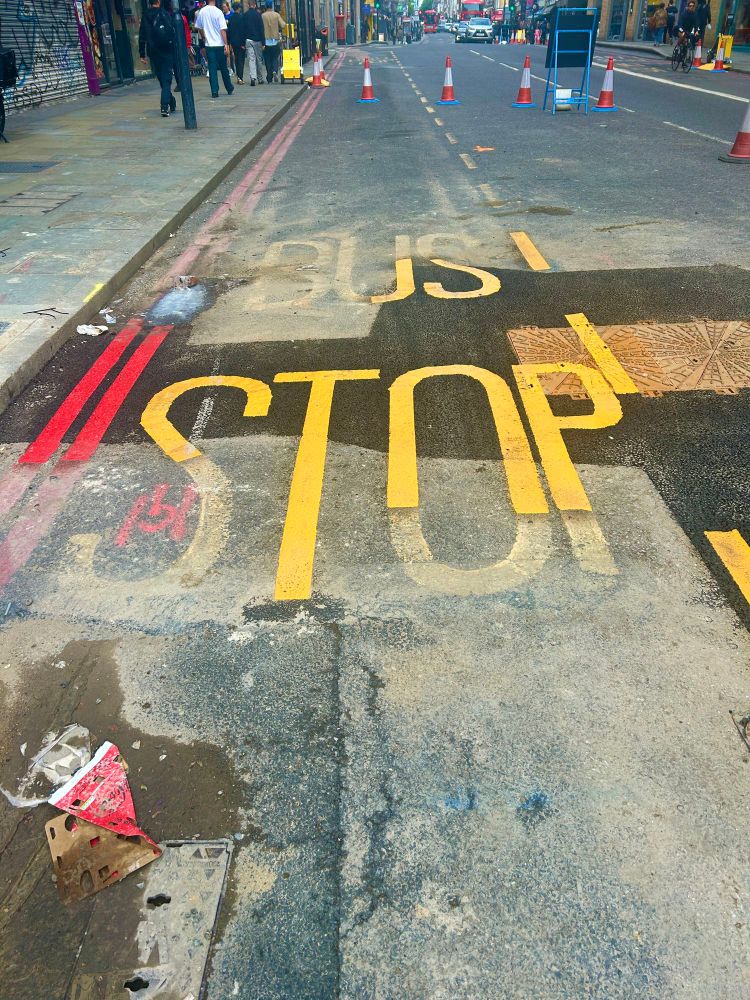 Half painted bus stop sign