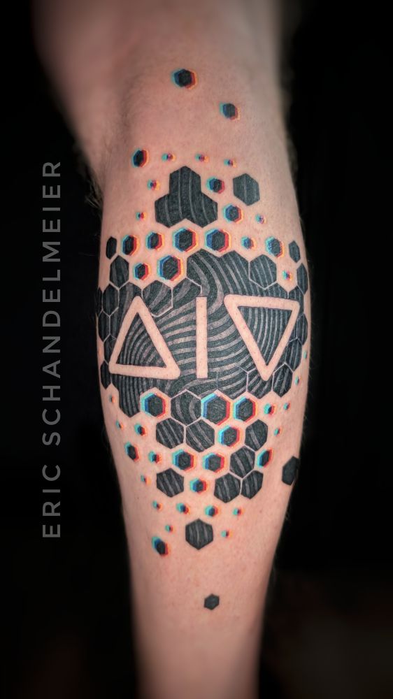 Geometric abstract tattoo of cmyk glitched hexagons on the back of a leg 