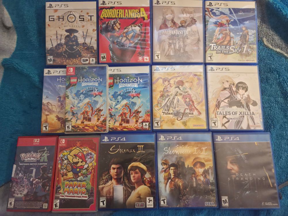 Picture Shows 14 games:

Ghost of Yotei for the PS5
Borderlands 4 for the PS5
Final Fantasy Tactics for the PS5
Trails in the Sky first chapter for the PS5
Horizon Zero Dawn remastered for the PS5 
2 copies of Lego Horizon Adventures for the switch and PS5 
Tales of Graces f remastered for the PS5
Tales of Xillia remastered for the PS5
Pokemon legends Z-A for the Switch 2
Paper Mario and the Thousand year door for the Switch
Shenmue 1,2 and 3 for PS4
And Death Stranding for the PS4