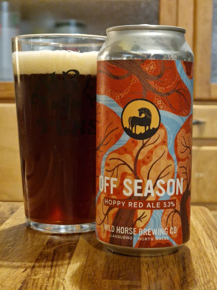 440ml can of beer. Off Season Hoppy Red Ale. 5.3% . Wild Horse Brewing Co. Llandudno, North Wales. The artwork on the can uses autumnal reds, oranges, pinks with a little bit of crisp blue sky