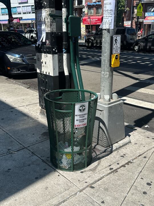 Picture of newly installed trash cans on Roosevelt Avenue 