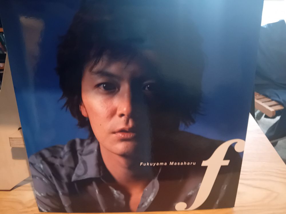 Front cover of what looks like a vinyl record of Fukuyama Masaharu's 2000 album "f." It's a big picture of his face. He is rather handsome. 