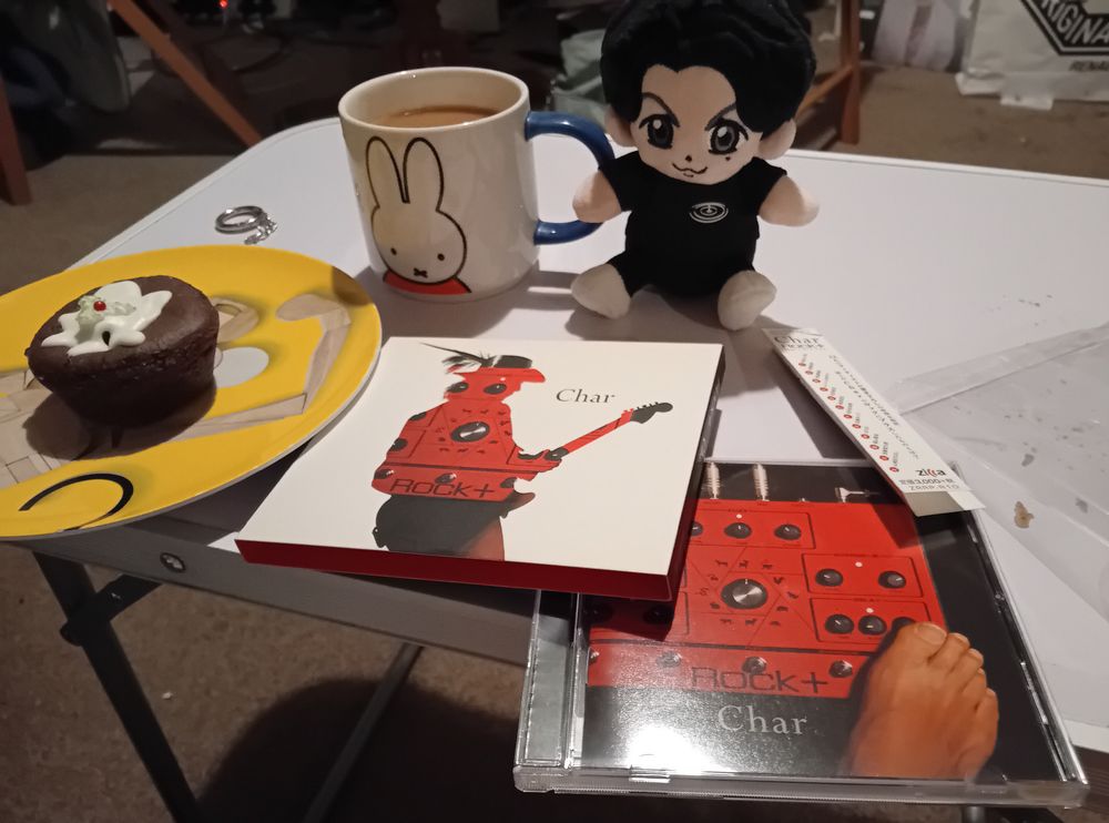 A CD of Char's 2015 album Rock+ on a table with a Fukuyama Masaharu cuddly toy. There is also a mug of tea with a picture of Miffy on it, and a plate with a mince pie cookie from Wenzel's for some reason. 7月７日 means 7 July, by the way, I couldn't fit that in the post.