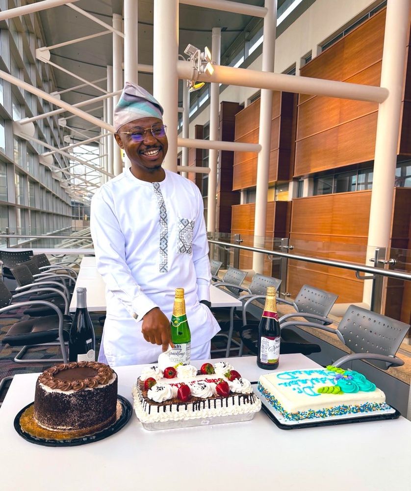 New PhD, Dr. Isaiah Adelabu with his celebration cakes 