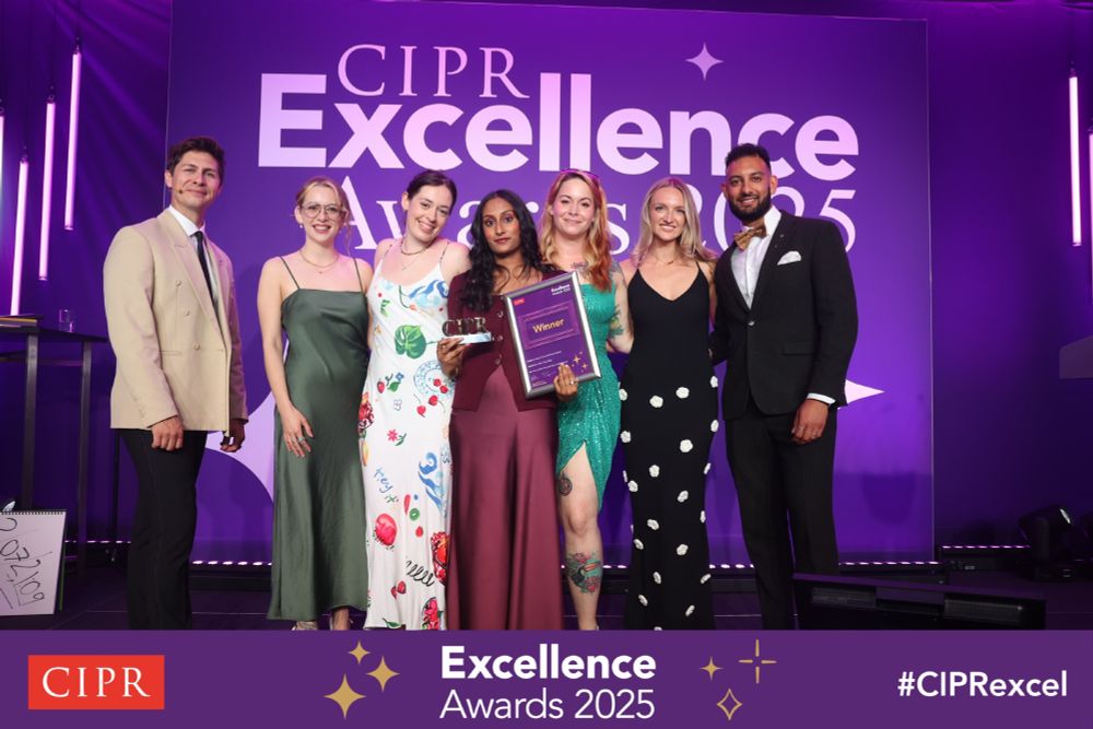 Group of seven individuals posing with an award at the CIPR Excellence Awards 2025.