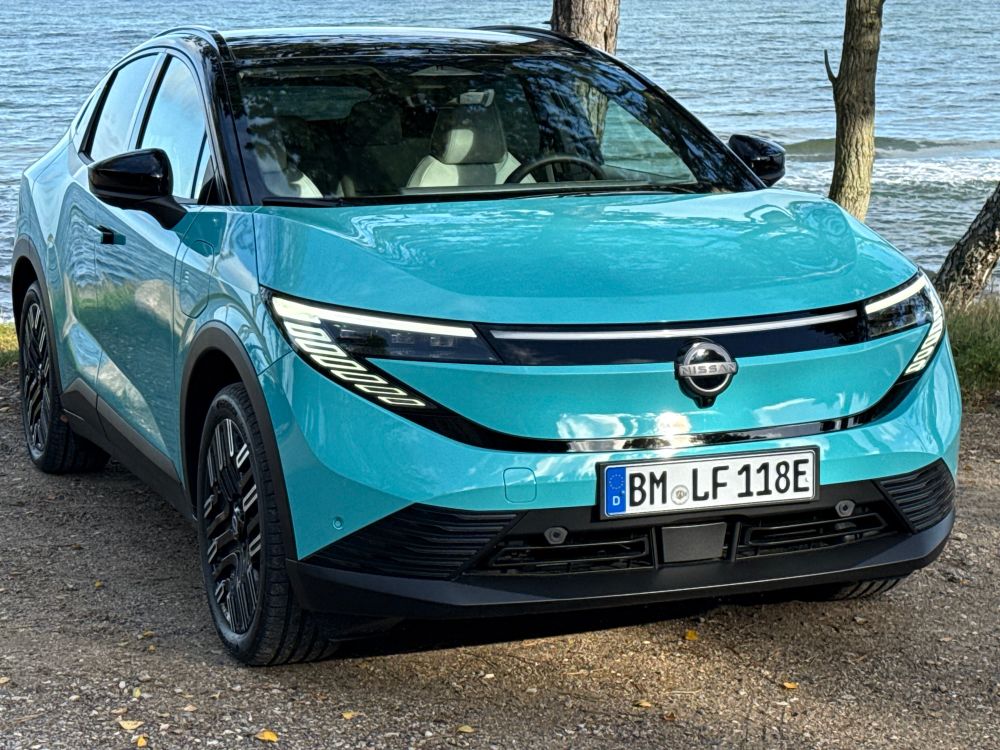 Front view of the new Nissan leaf again parked by the seaside and again resting in dappled sunlight in northern Denmark