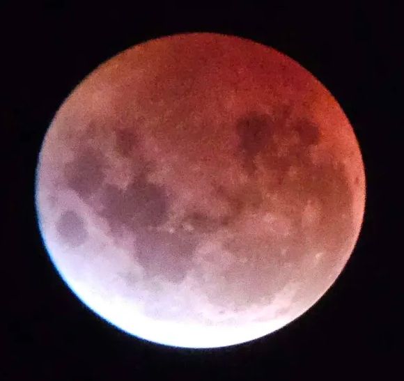 an image of the moon in the march 2025 lunar eclipse. it's similar to the first image, but has slightly less light bloom in the white section.