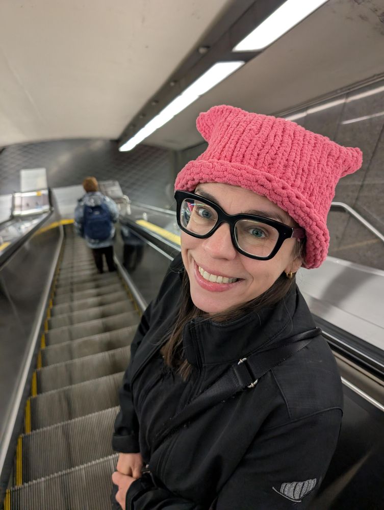 Maj in her pussy hat on the escalator in Metro Laurier