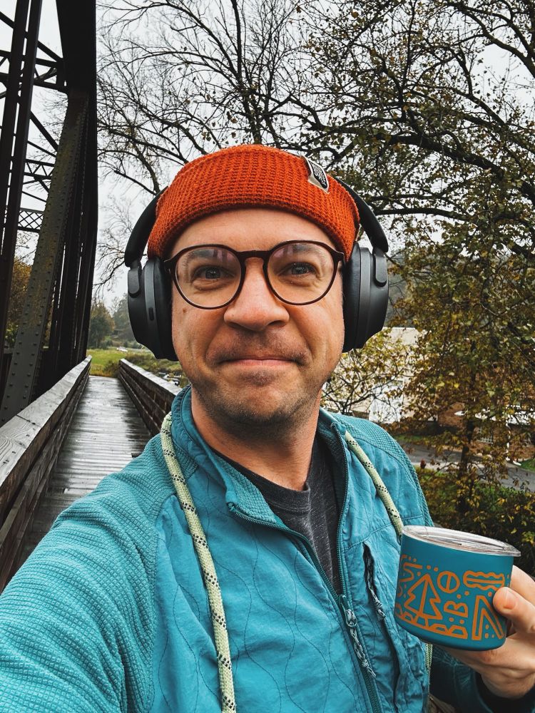Selfie outside on a bridge on a cloudy fall morning.