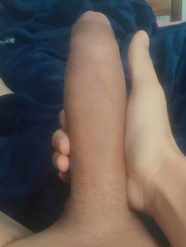 Close up of me holding my morning wood in my right hand while laying down in bed