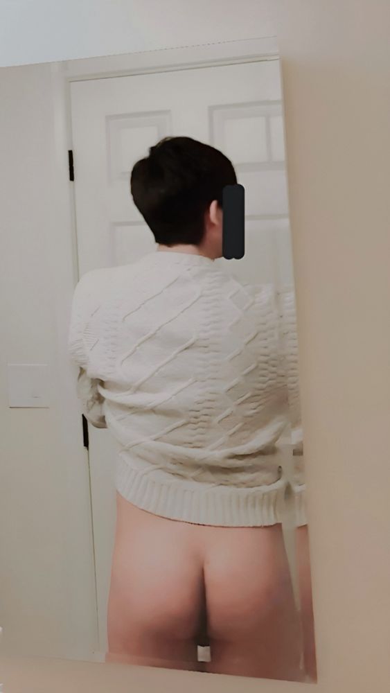 Bathroom mirror pic of me wearing an off-white knit sweater and nothing else. I am facing away to show my backside, lifting my sweater to show my butt. My face is blocked out by a couple of black lines and my legs are out of frame.