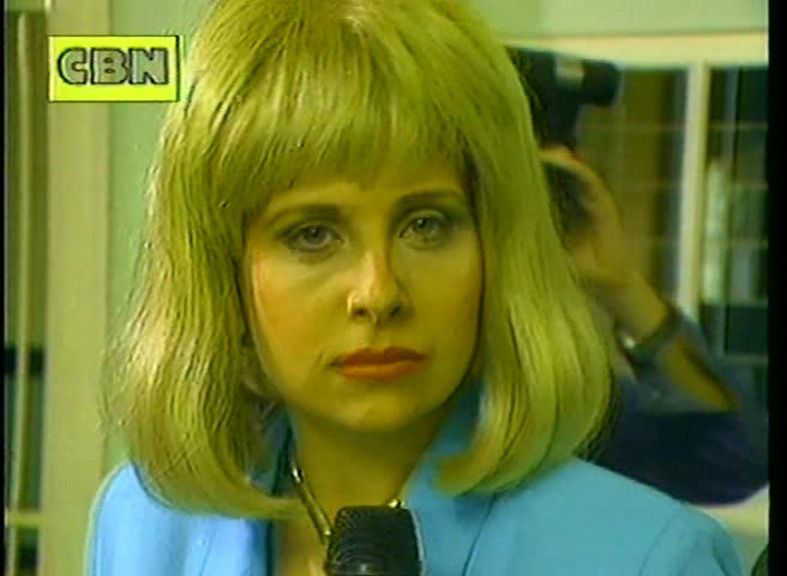 Rebecca Front playing the excessively earnest, blond bewigged and shoulder-padded TV news reporter Barbara Wintergreen in the 1990s news satire The Day Today