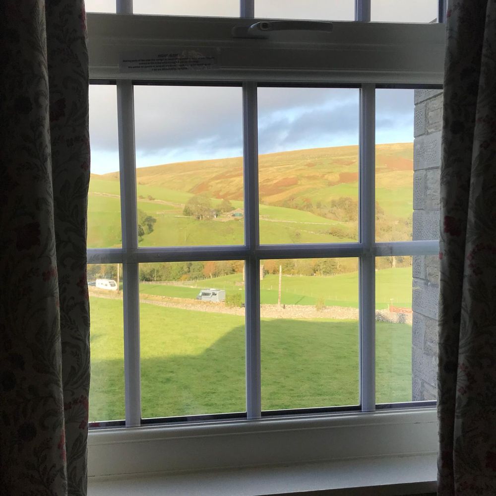 View out of a window over a gently rolling hillside 